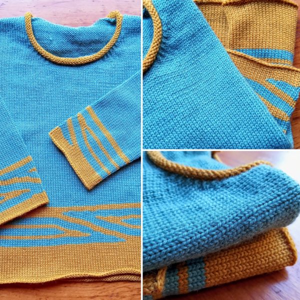 Pull tricoté en jersey bi-couleur avec un petit bord rond.
