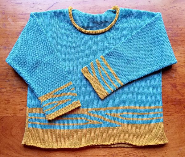 Pull enfant mixte, graphisme couleur, manches longues, col rond tricoté en jersey.